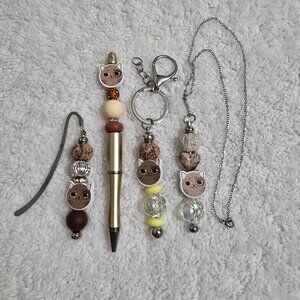 Neutral Cat Charm Bundle – Gold Pen, Bookmark, Keychain & Necklace Set